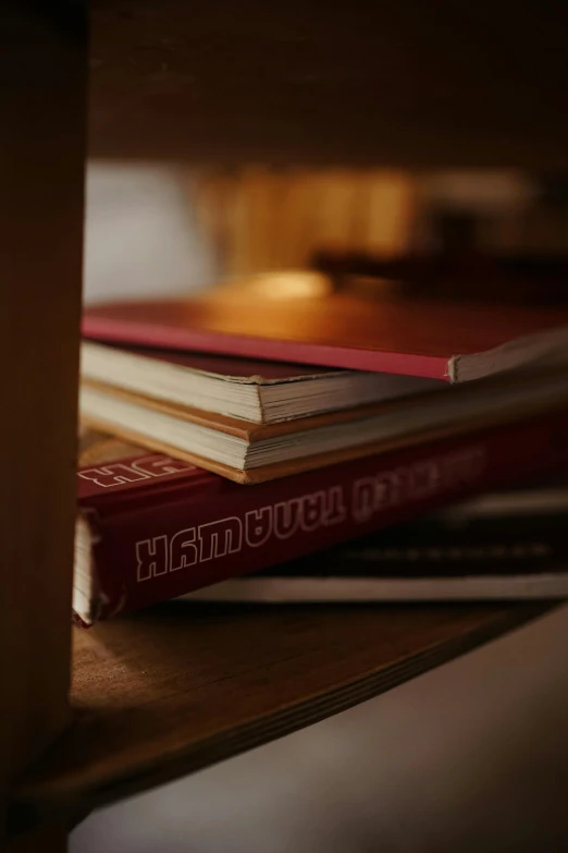 a stack of red books sit on a counter