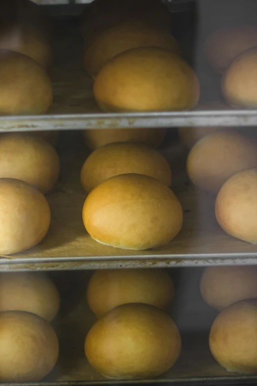 a shelf of oranges with one half empty in the foreground