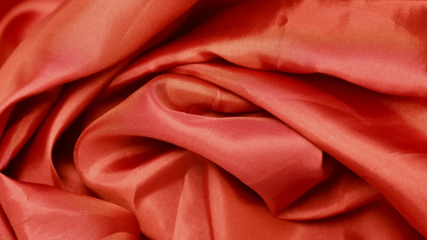 a po of red fabric material that is folded out