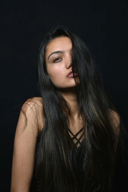 a close up of a woman with long hair and bangs