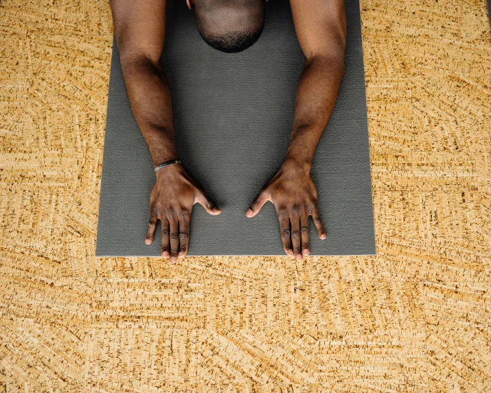 a man kneeling down on top of a mat