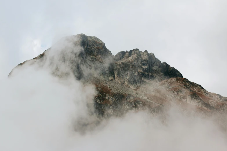 very foggy mountain with very thick clouds and low peaks