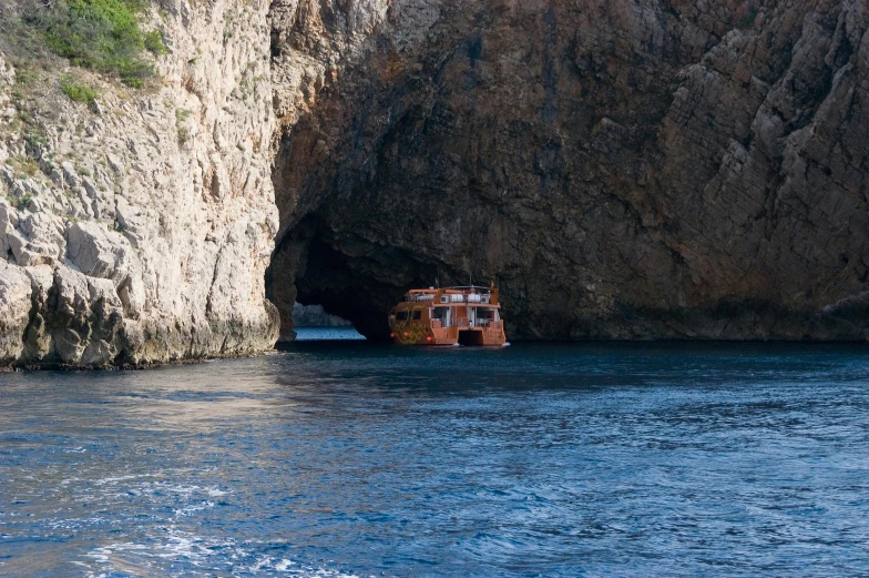 a small boat in a bay at an island