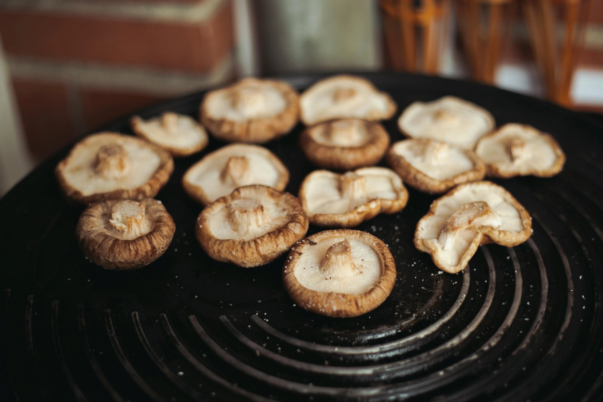 a group of mushrooms is being cooked on a grill