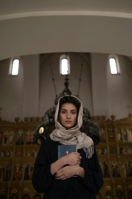 a woman in a church wearing a scarf around her head