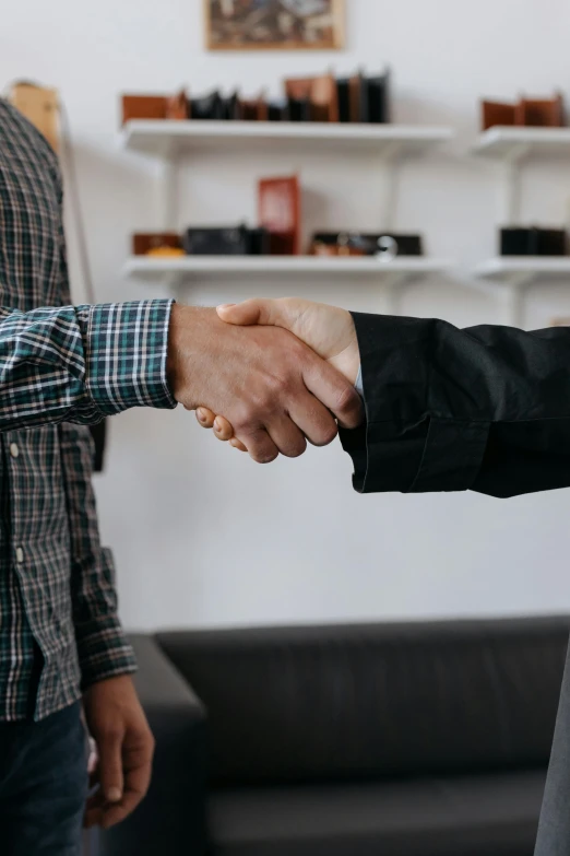 a close up of two people shaking hands