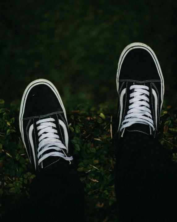 a person is wearing black and white shoes