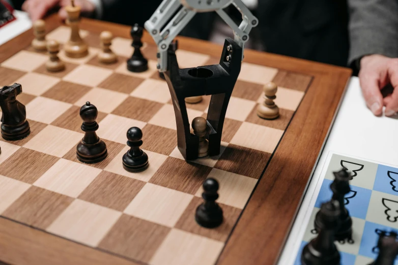 a chess board that is on the wooden table