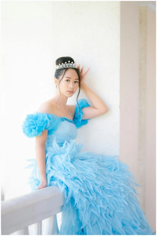 a beautiful young lady wearing a blue dress