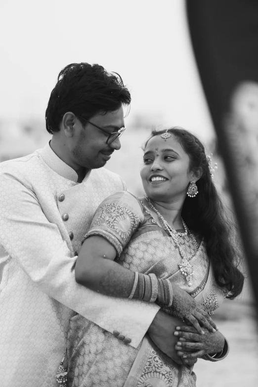 a black and white po of a smiling indian couple