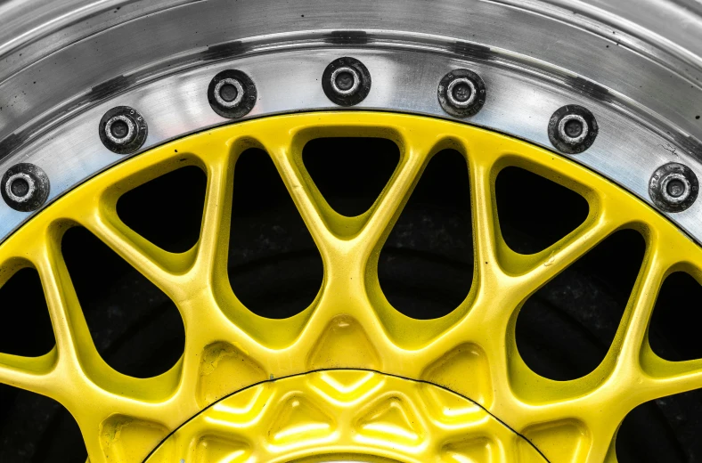 the wheel is shiny and has yellow painted spokes