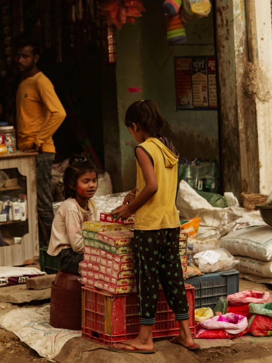 a little girl that is by a basket with some food