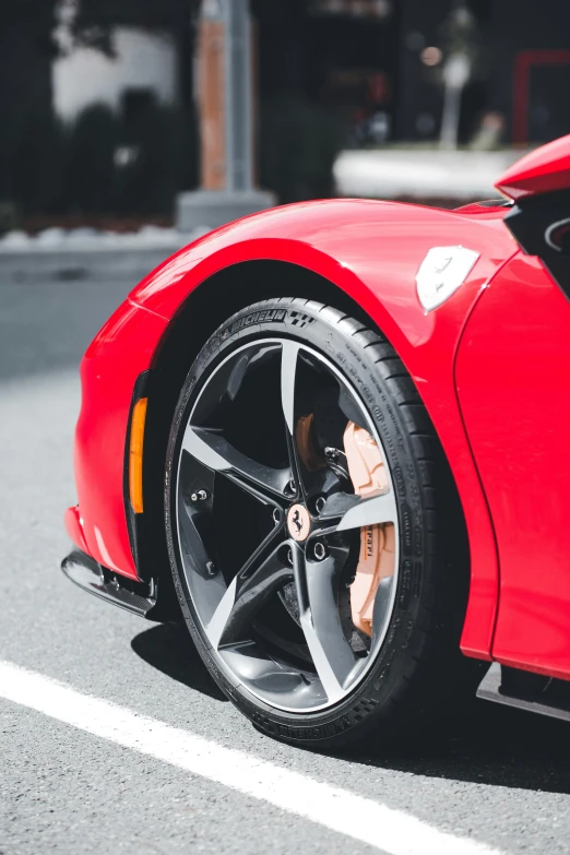 the rear wheel of a red sports car