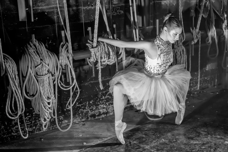 a girl in tulle playing with chains