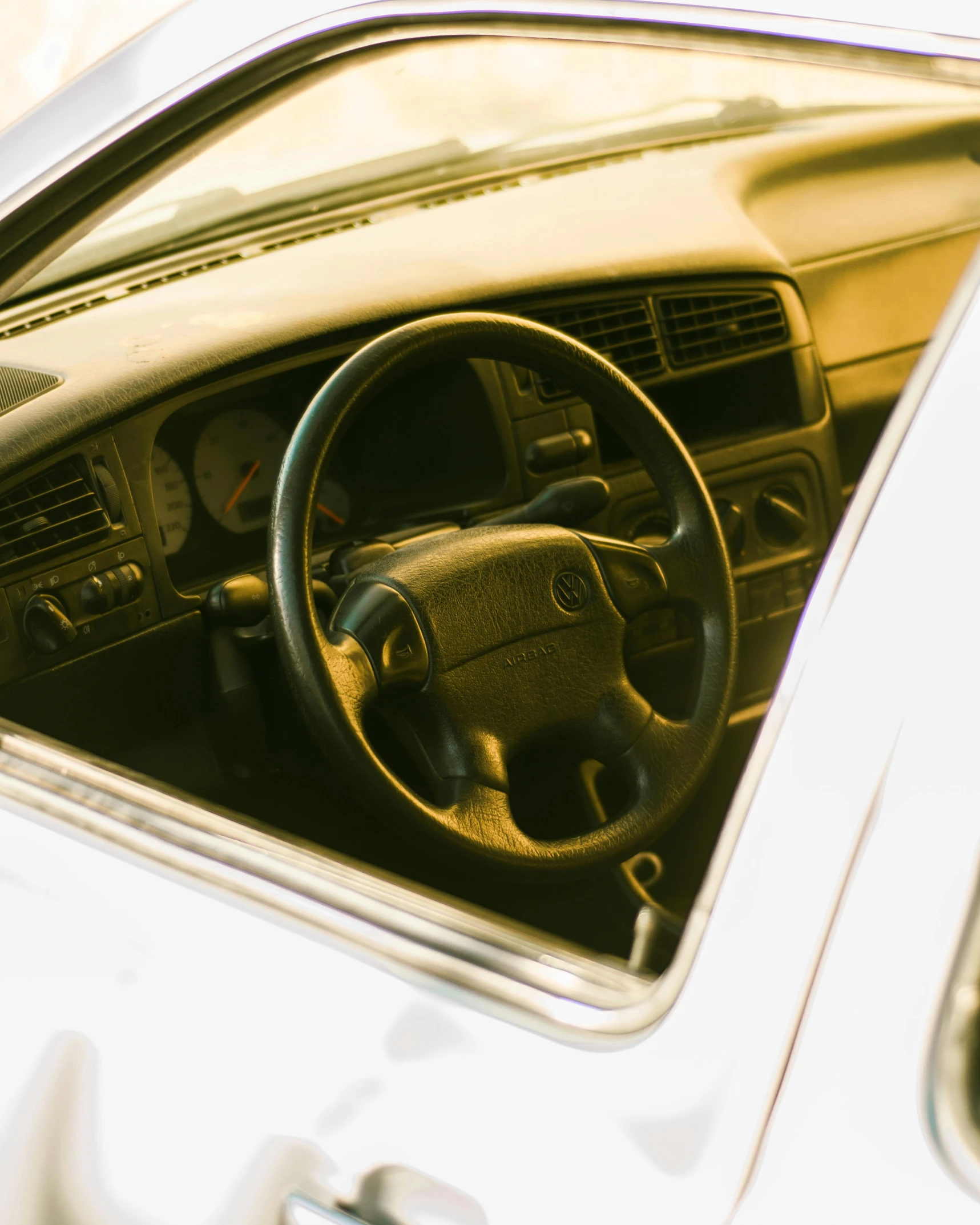 a car dashboard with a steering wheel and dashboard board