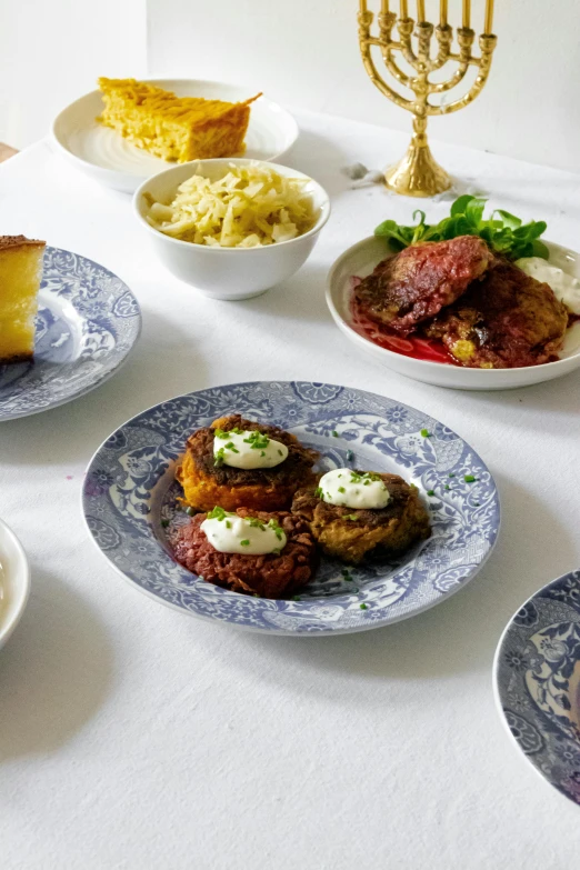 a dinner table with food and a candle