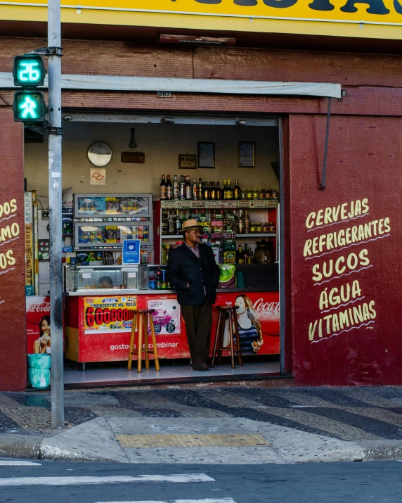 a man stands outside of a small store