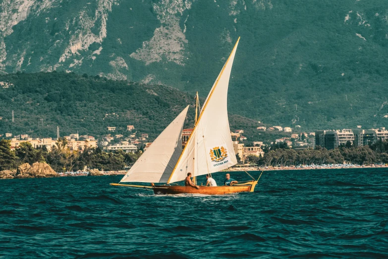 two people sail their boat in the water