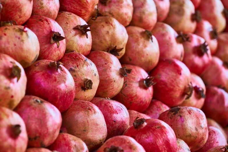 many rows of pomegranates stacked on top of each other