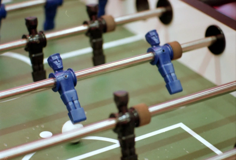 a close - up of a foosball table with plastic figurines in it