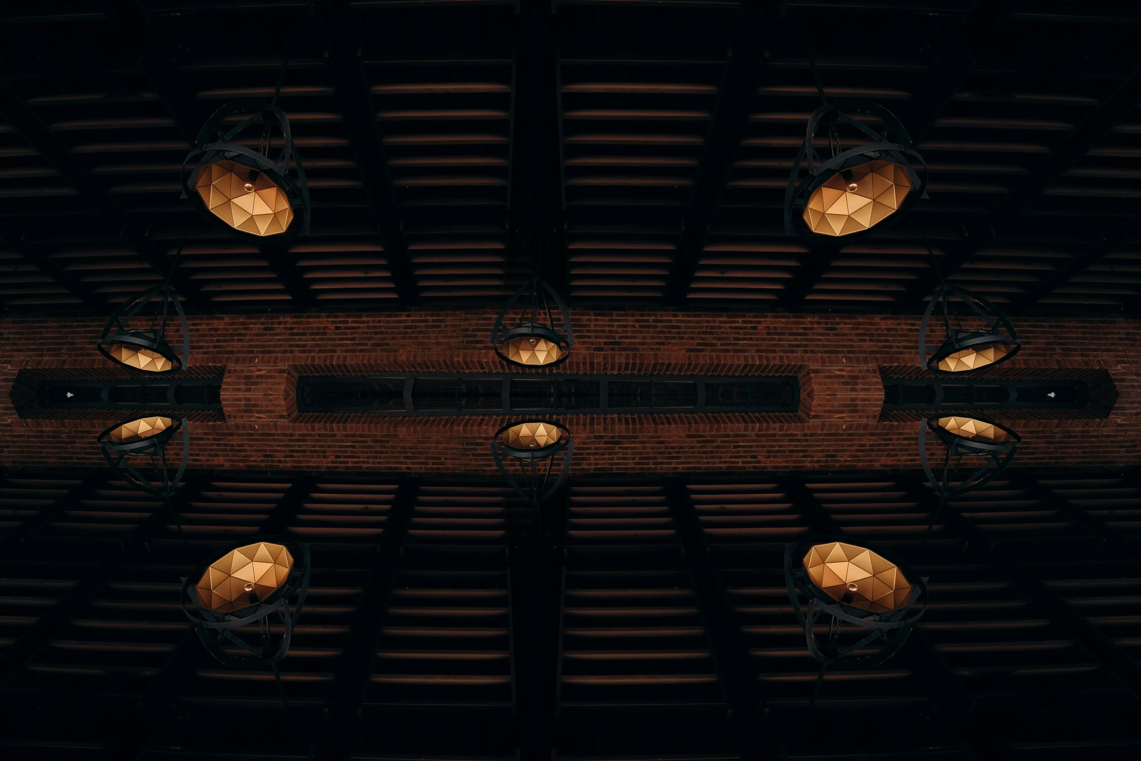 overhead view of a ceiling made out of a wooden panel