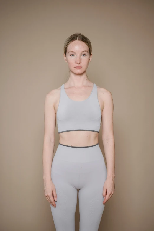 the  is standing in her yoga wear