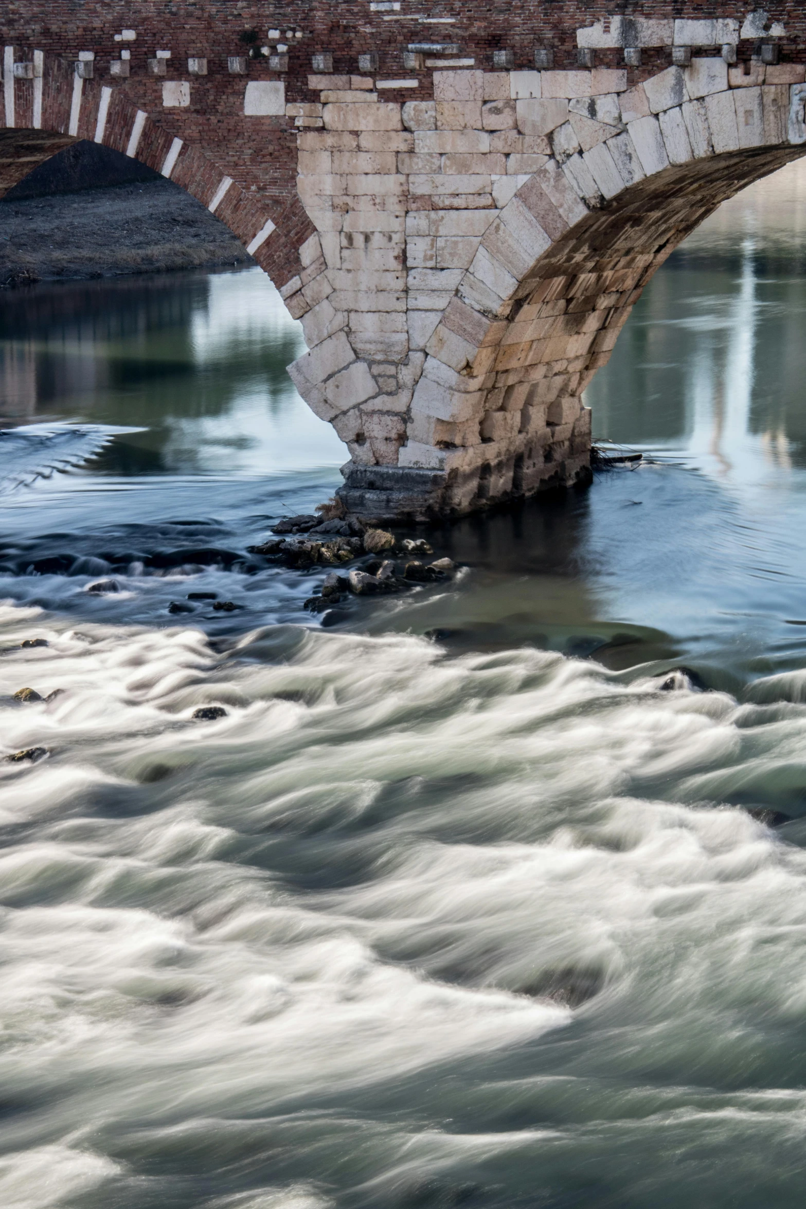 a very tall bridge over some rough water