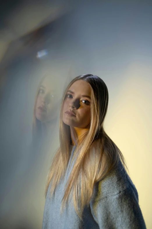 a woman standing behind a curtain in the background