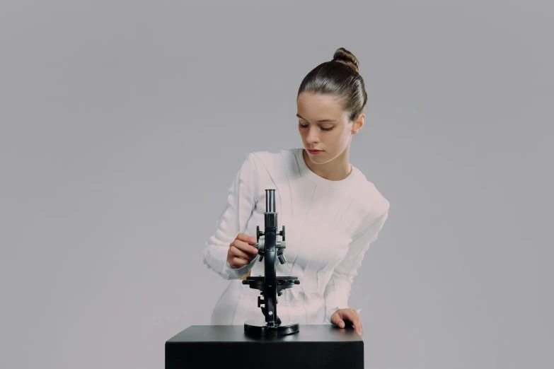 a woman is shown looking at her camera using a microscope