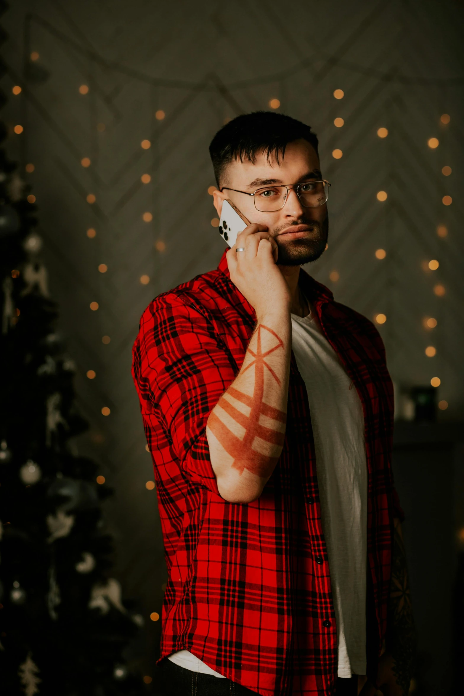 a man in a red and black plaid jacket on the phone