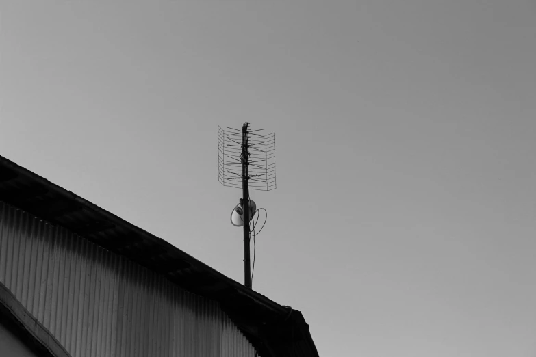 black and white pograph of a tower with weather vane