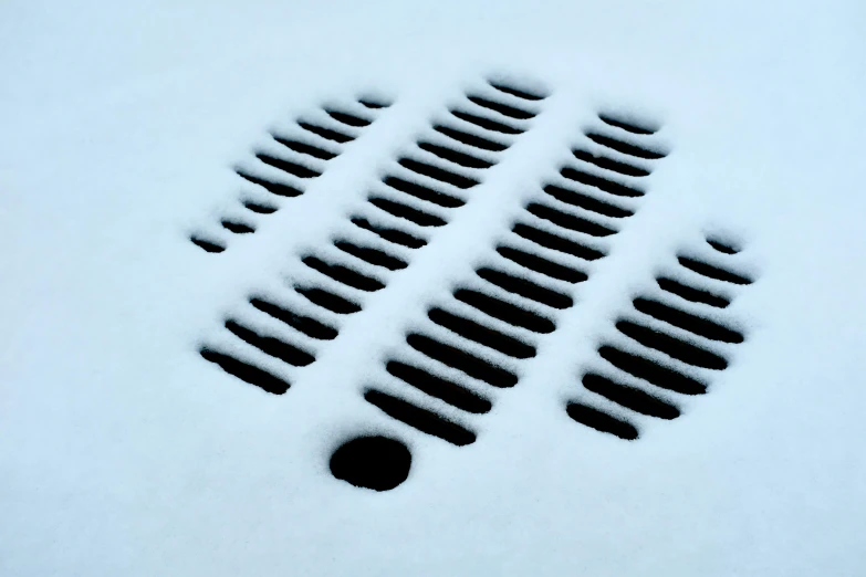 several circles and a hole are shown in the snow