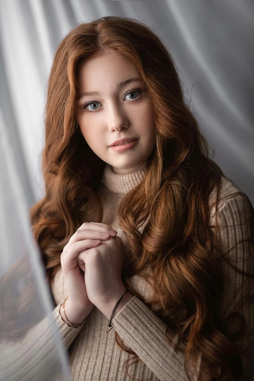 girl with long red hair and blue eyes posing for portrait