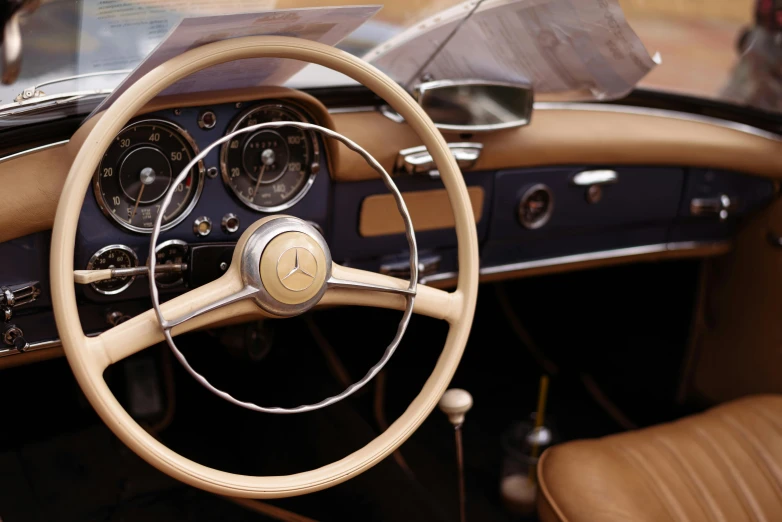 a steering wheel and dashboard in an old car