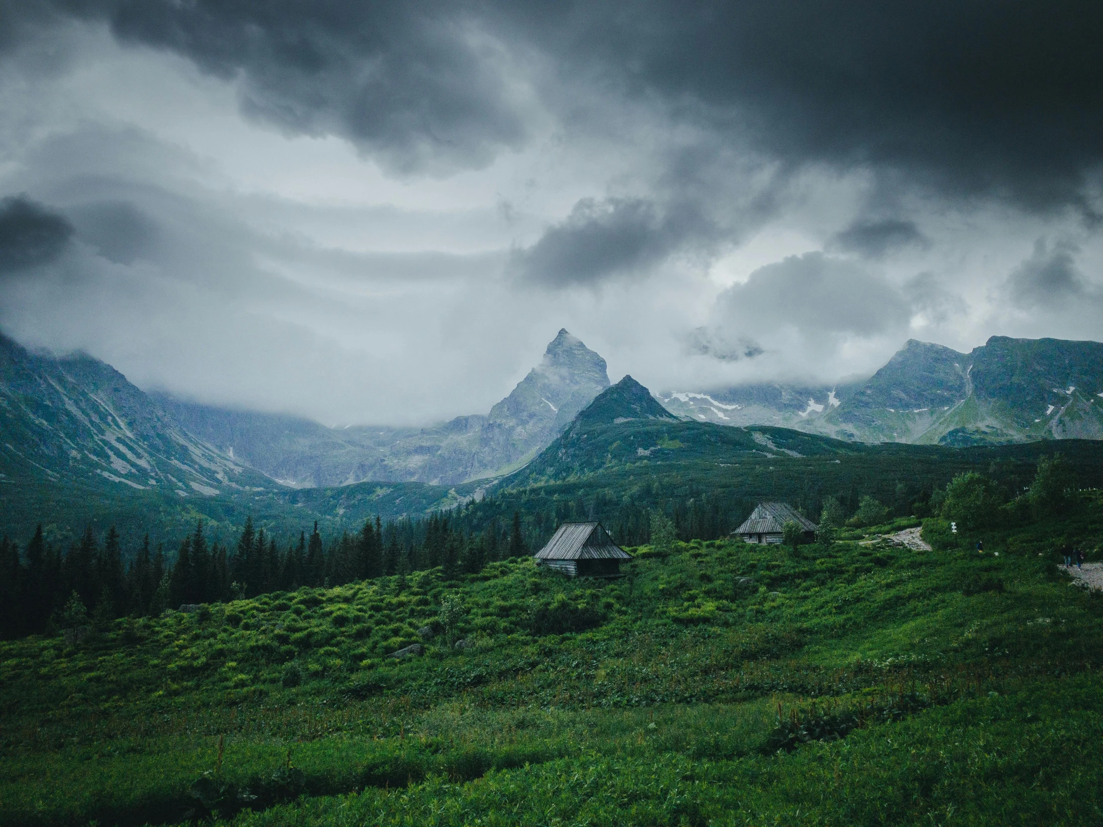 a scenic view of mountains under a cloudy sky