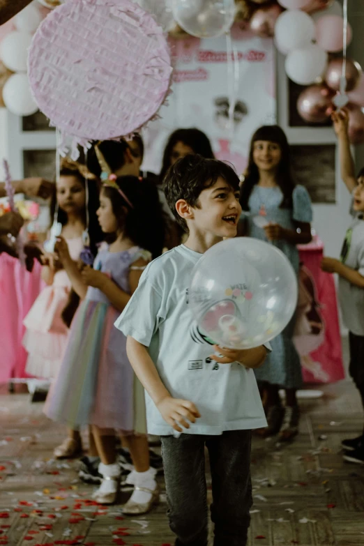 a  holding a bubble ball with other children