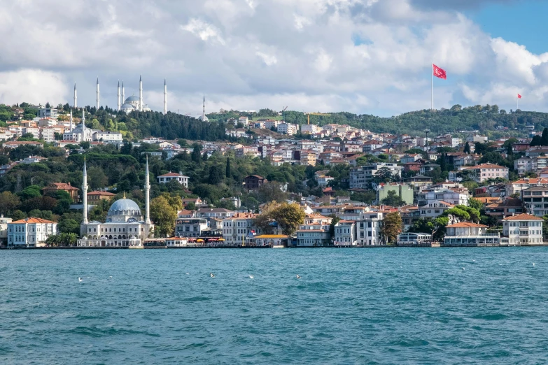 there is a boat sailing on the water in front of a city