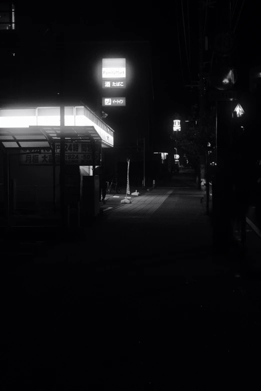 a bus stop on a city street at night