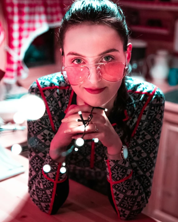 a woman wearing glasses with a red light around her