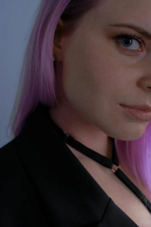 a woman with bright pink hair, wearing a neck tie