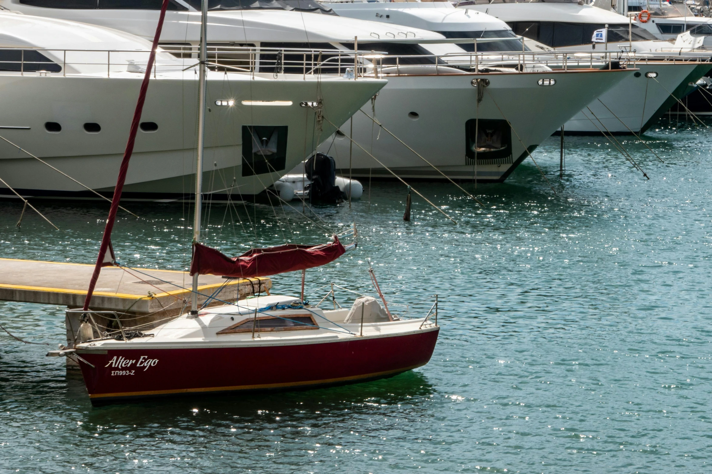 the water that is calm has a dock for boats