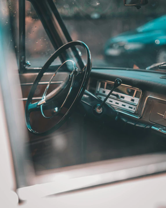 the steering wheel and dashboard of an old car