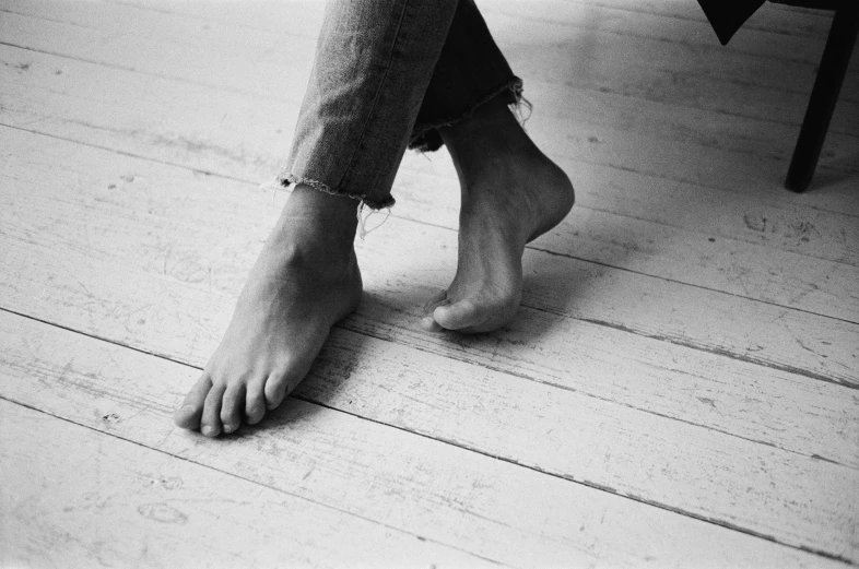 bare feet are seen on the floor of a home