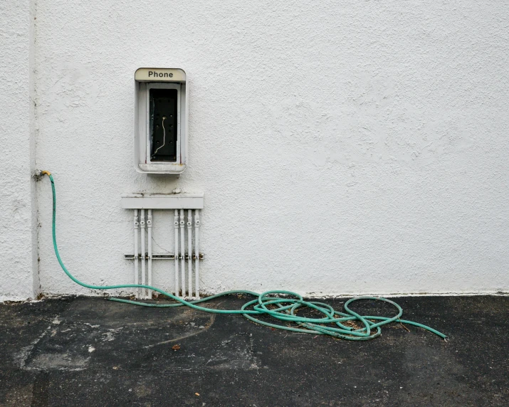electrical wires and an outlet in front of a wall