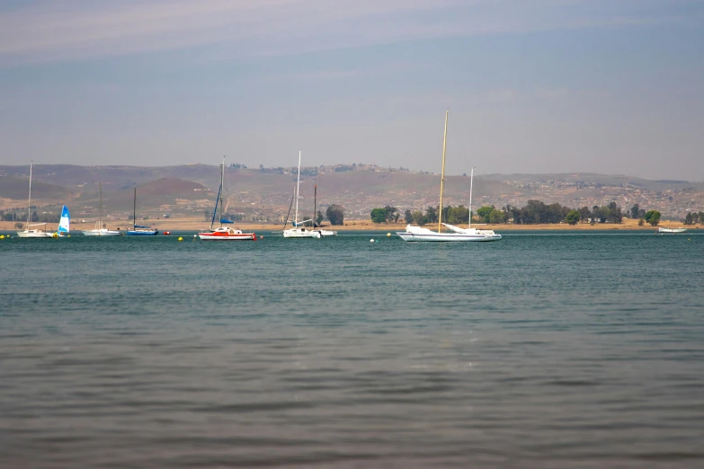 boats are sailing on the water off the coast