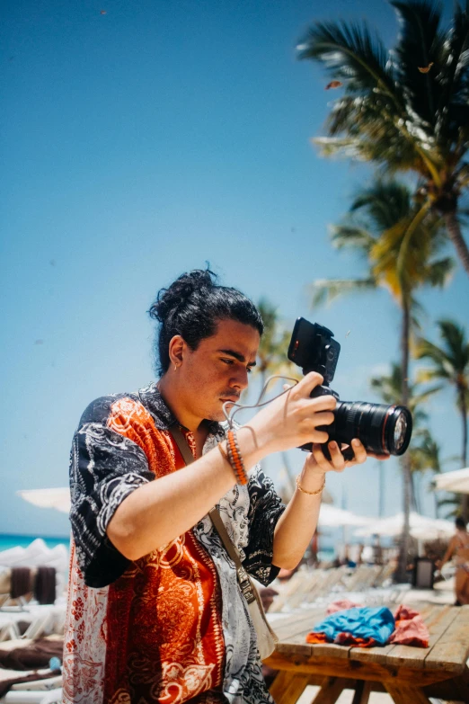 a person on the beach taking a po with a camera