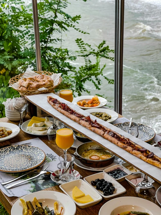 an assortment of prepared food including bread, fruits and soups