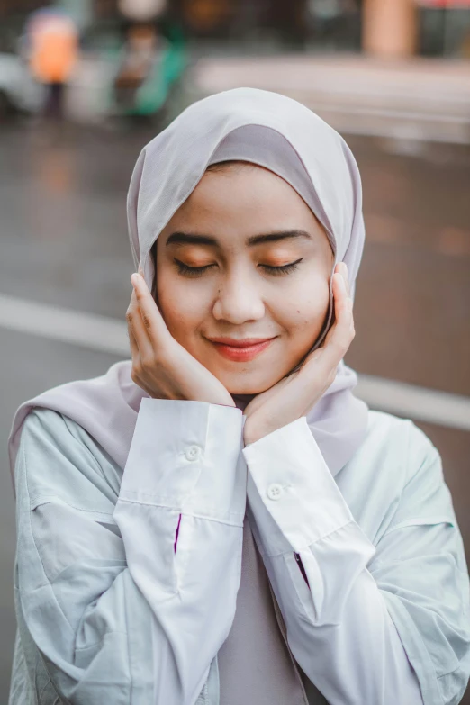 a woman with her hands on her cheek