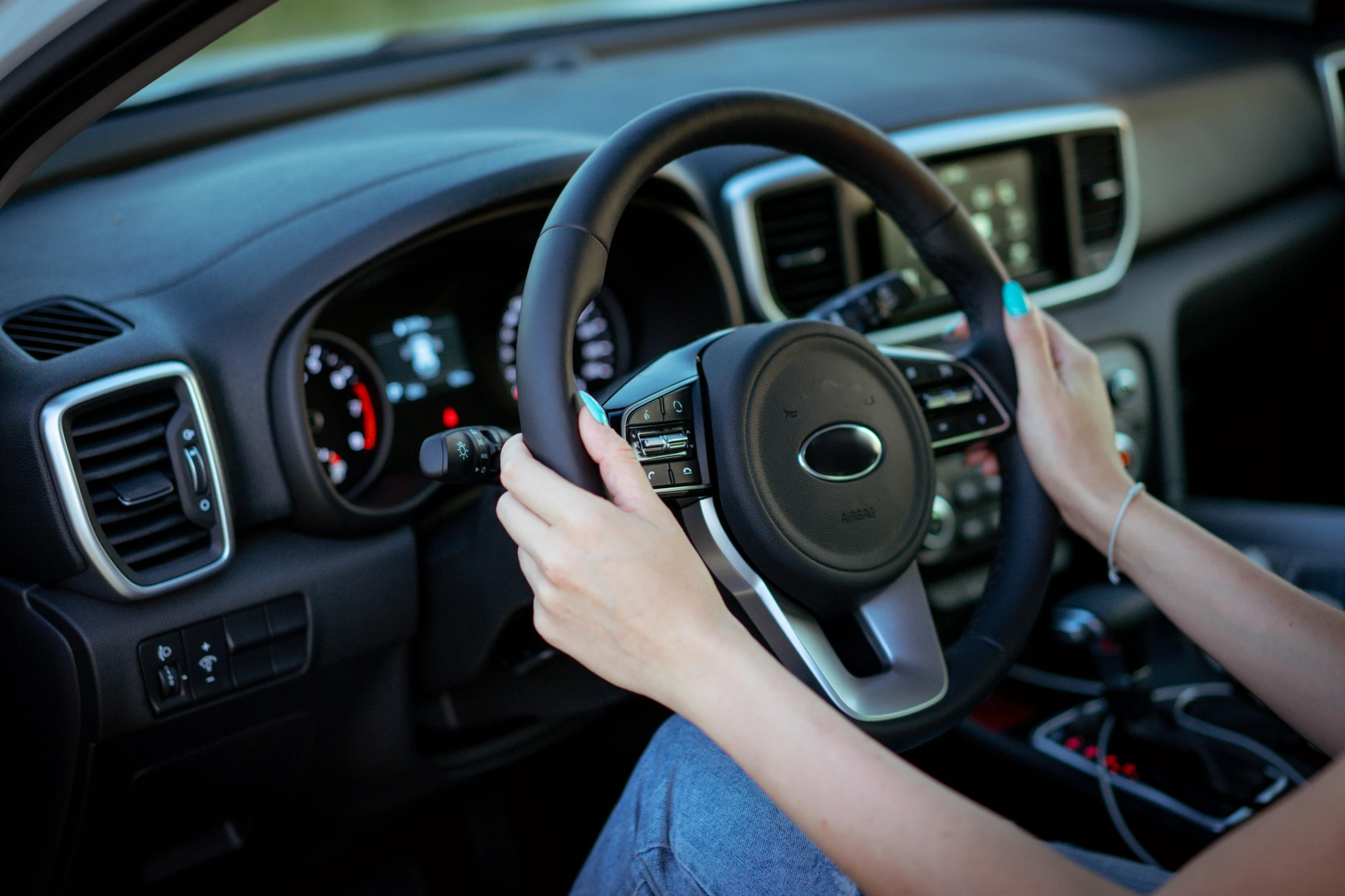 woman driving a car while holding the steering wheel