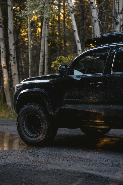 a truck sits in the middle of a wet road